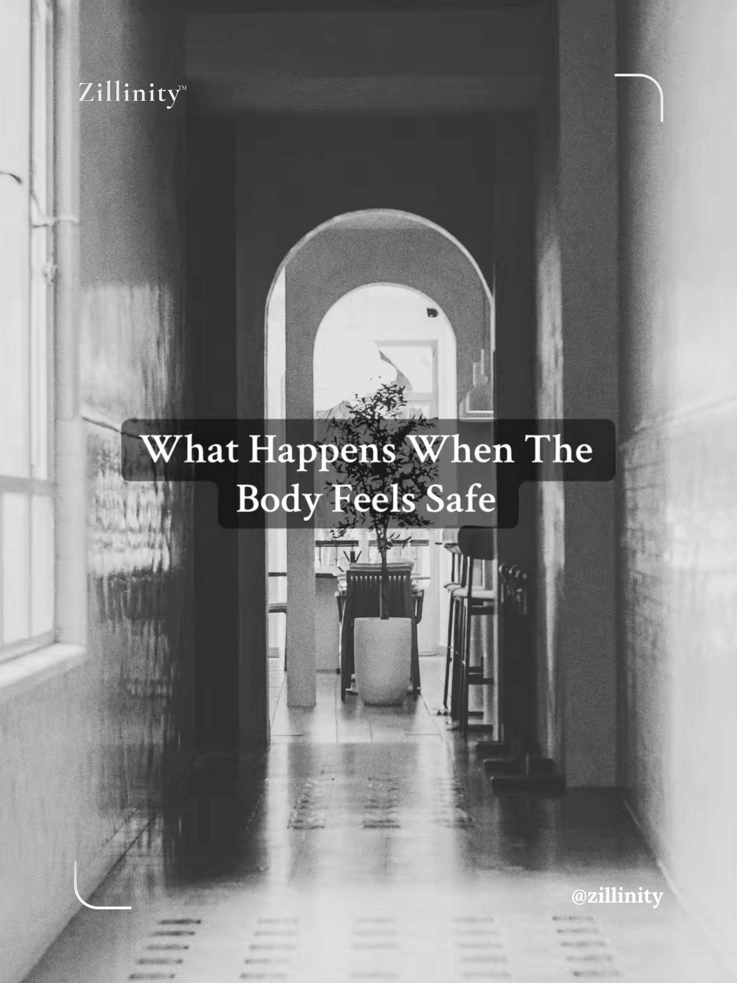 A long hallway with arched doorways and columns. Sunlight streams through windows on the left, illuminating the polished floor. A potted plant sits on a table in the distance. Text overlay reads "What Happens When The Body Feels Safe" with "Zillinity" branding in top left and @zillinity handle in bottom right.